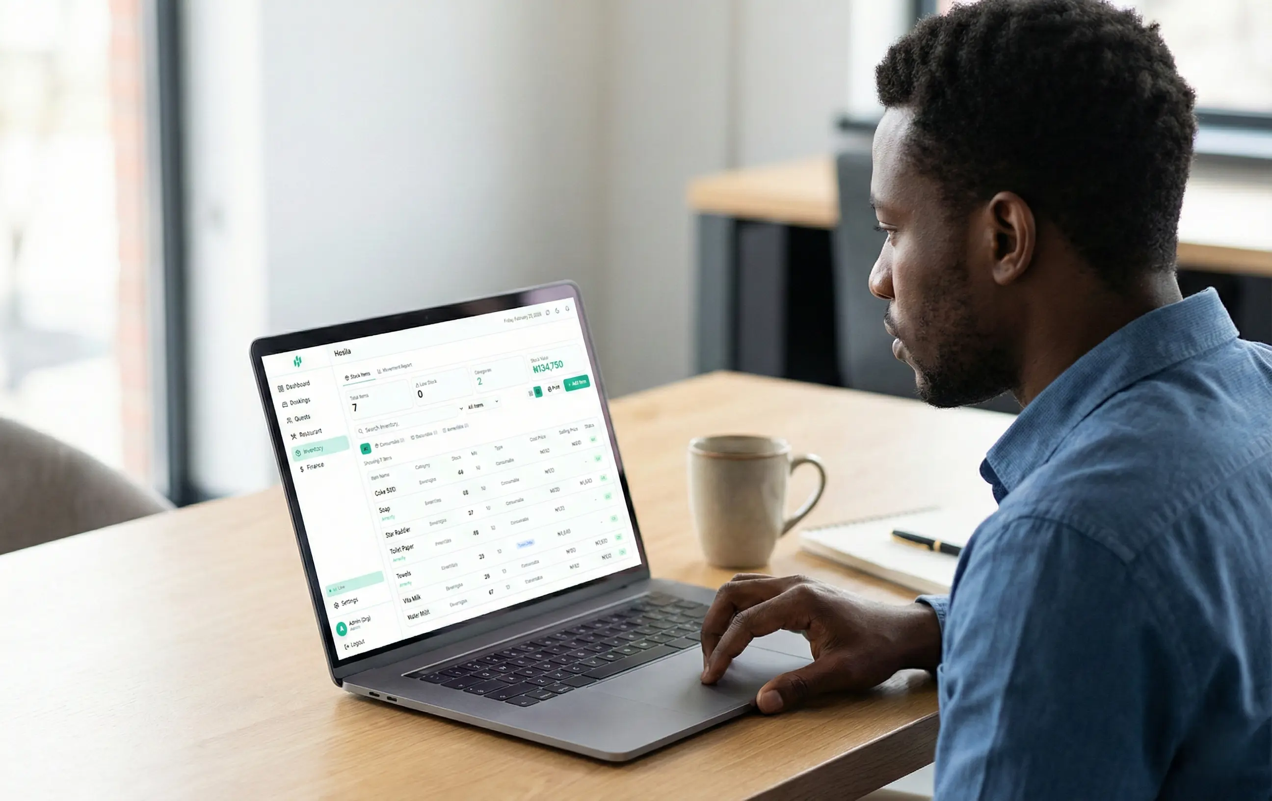 Hotel staff member using a tablet to manage inventory
